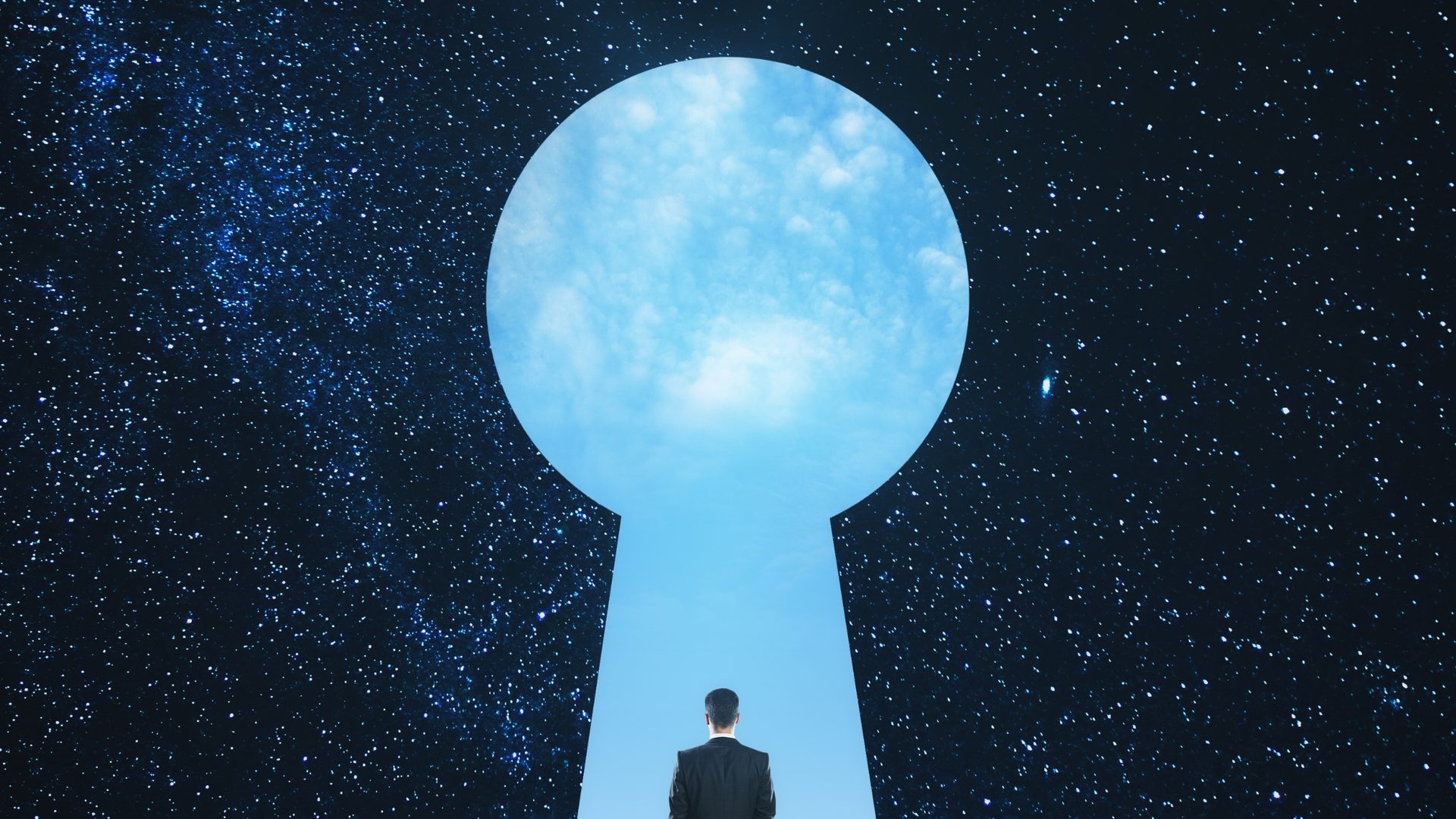 A person standing in a glowing keyhole-shaped doorway beneath a starry sky
